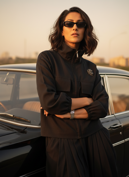 Black Draped pants & Black Shirt Jacket worn by a model, showcasing sustainable organic cotton fabric in an urban setting.